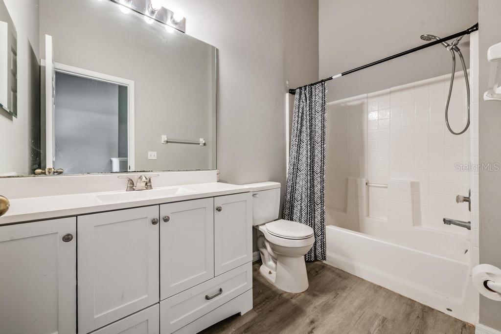 8512 Shallow Creek Court New Port Richey, FL 34653 - Photo 25 of 45 a bathroom with a sink toilet a shower and a mirror
