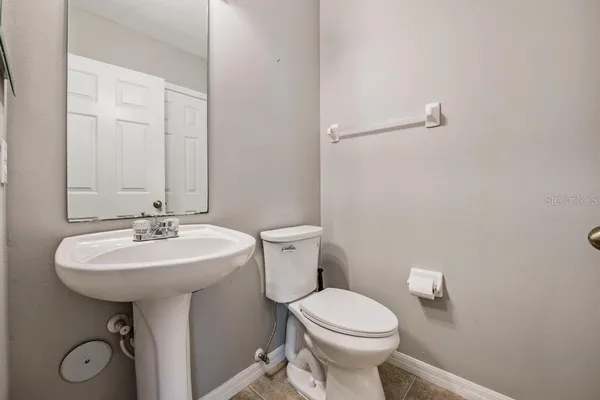 a bathroom with a sink a toilet and mirror