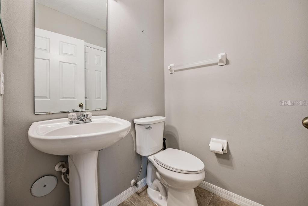 8512 Shallow Creek Court New Port Richey, FL 34653 - Photo 26 of 45 a bathroom with a sink a toilet and mirror