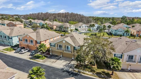 an aerial view of a house with a yard