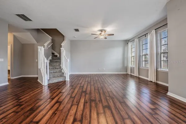 wooden floor in an empty room with a window
