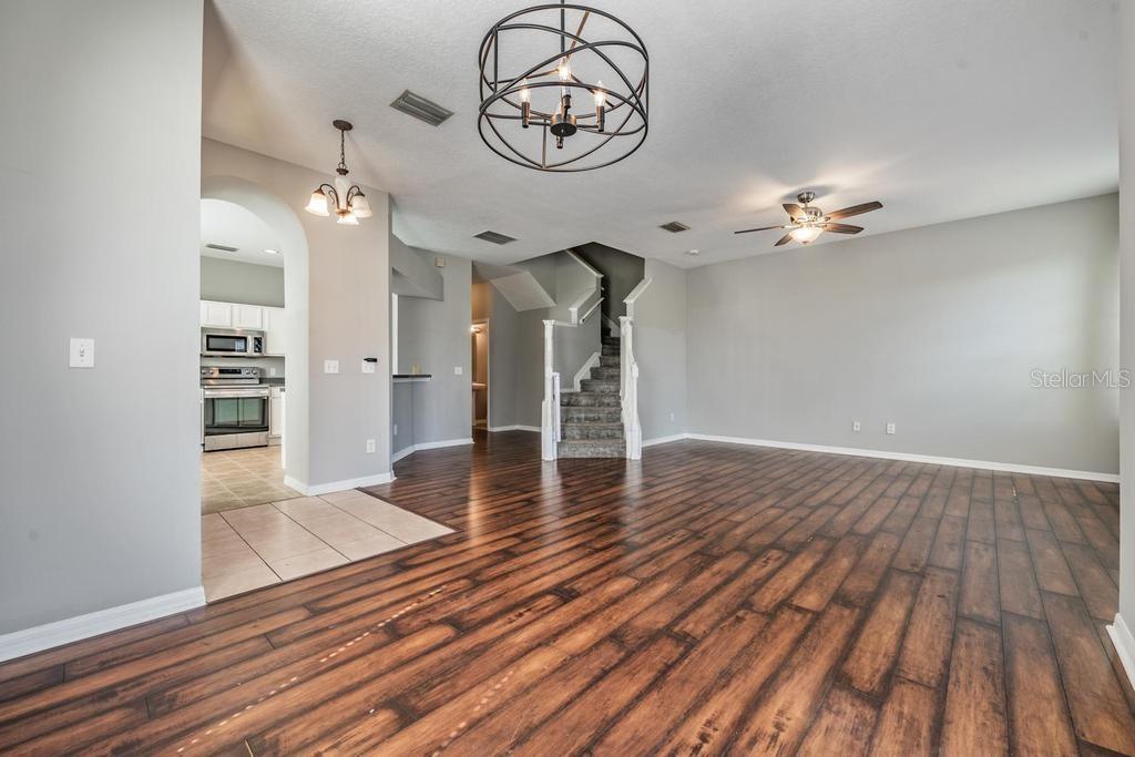 8512 Shallow Creek Court New Port Richey, FL 34653 - Photo 7 of 45 wooden floor in an empty room with a window