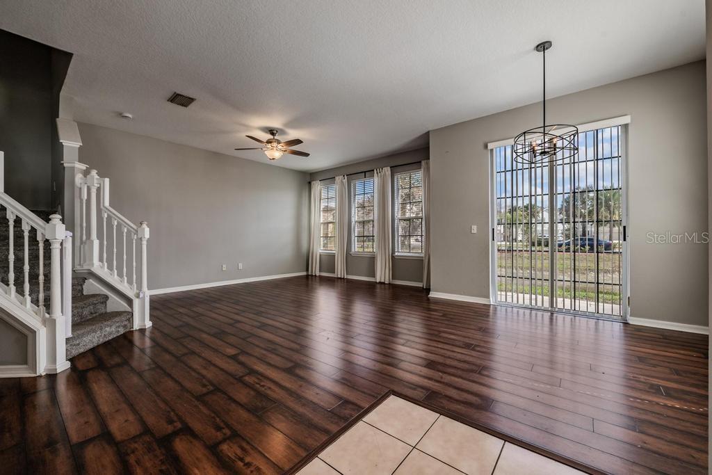 8512 Shallow Creek Court New Port Richey, FL 34653 - Photo 10 of 45 a view of an empty room with wooden floor and a window