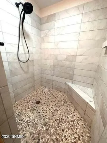 a view of walk in closet with clothes