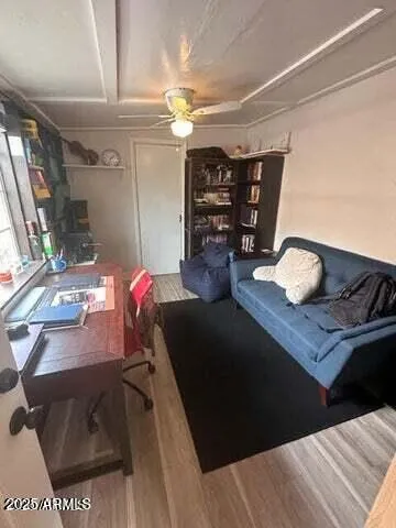 a living room with furniture and wooden floor