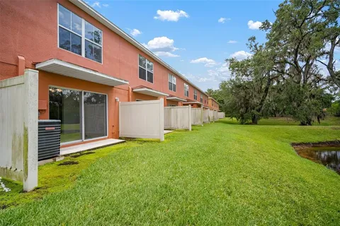 a view of a house with backyard and garden