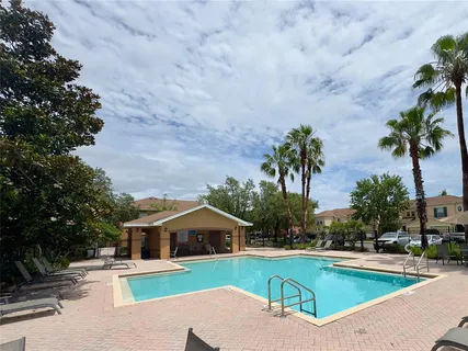 a view of house with outdoor space and swimming pool