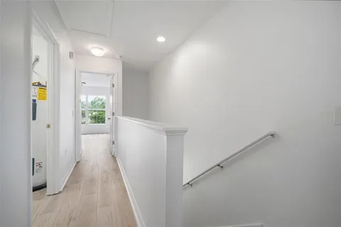 a view of hallway with wooden floor