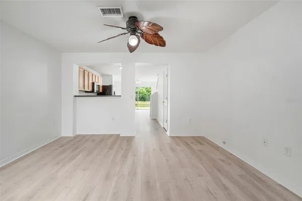 a view of empty room with wooden floor
