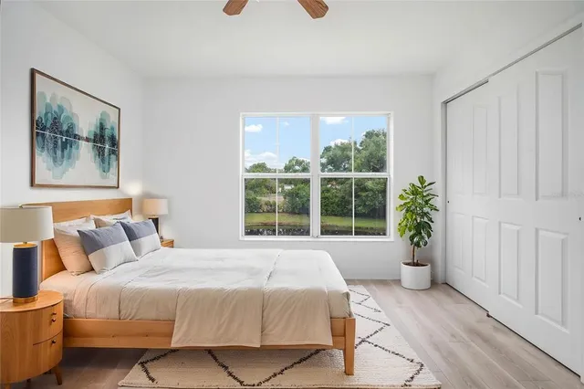 a spacious bedroom with a bed and a window