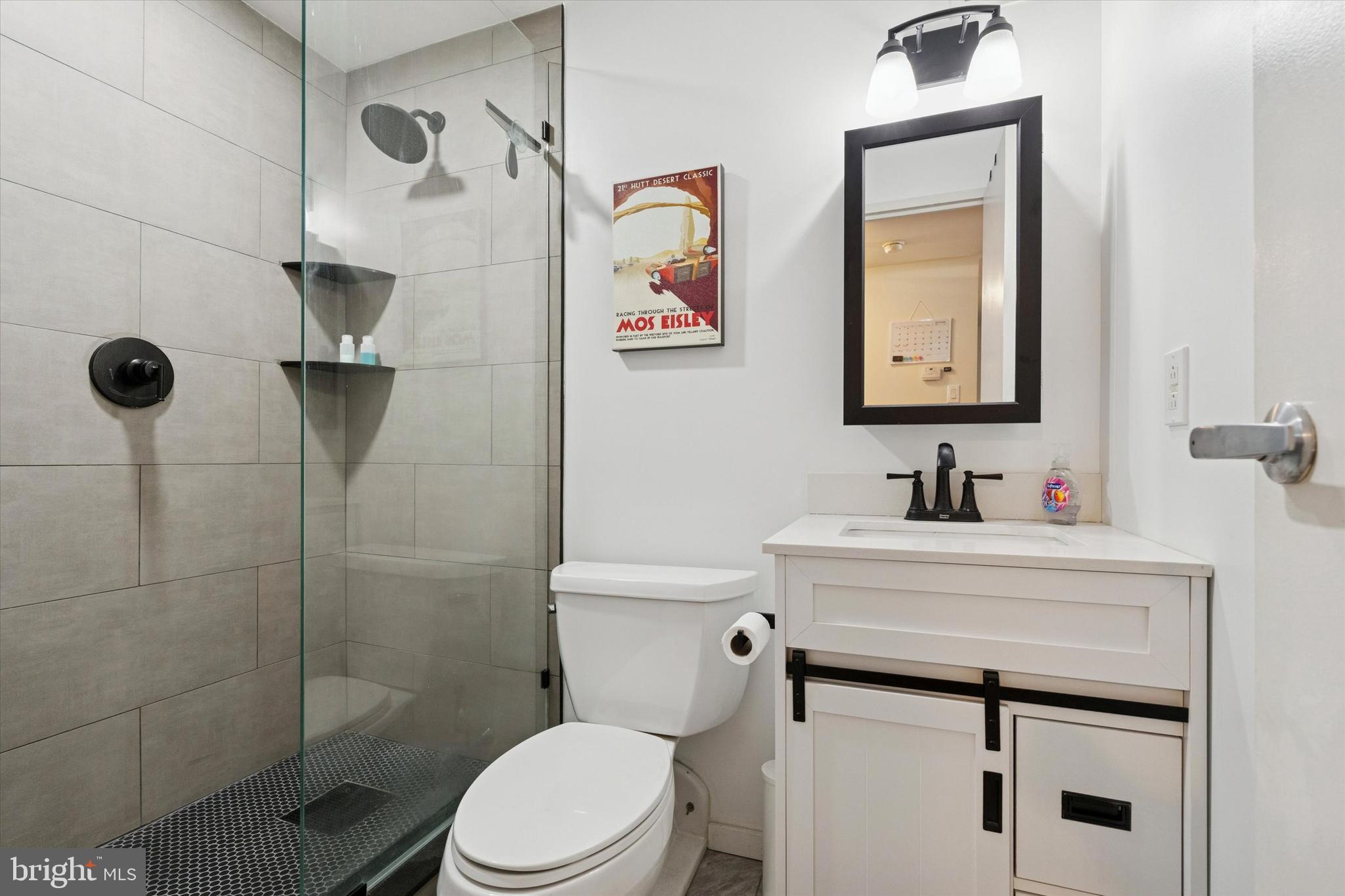 219 South 18th Street, Unit 902 Philadelphia, PA 19103 - Photo 11 of 14 a bathroom with a toilet sink vanity and mirror