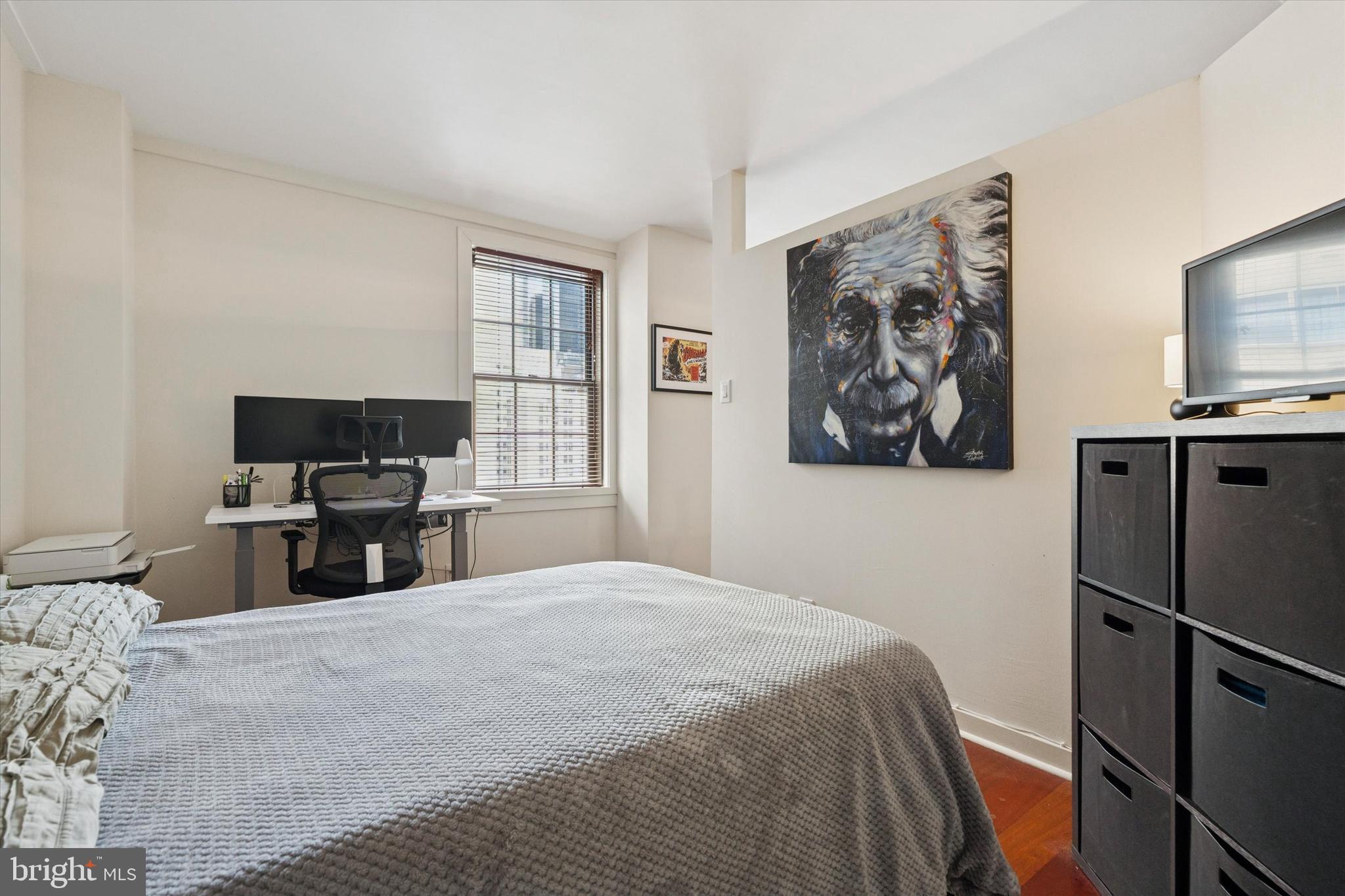219 South 18th Street, Unit 902 Philadelphia, PA 19103 - Photo 13 of 14 a bedroom with a bed and a flat screen tv