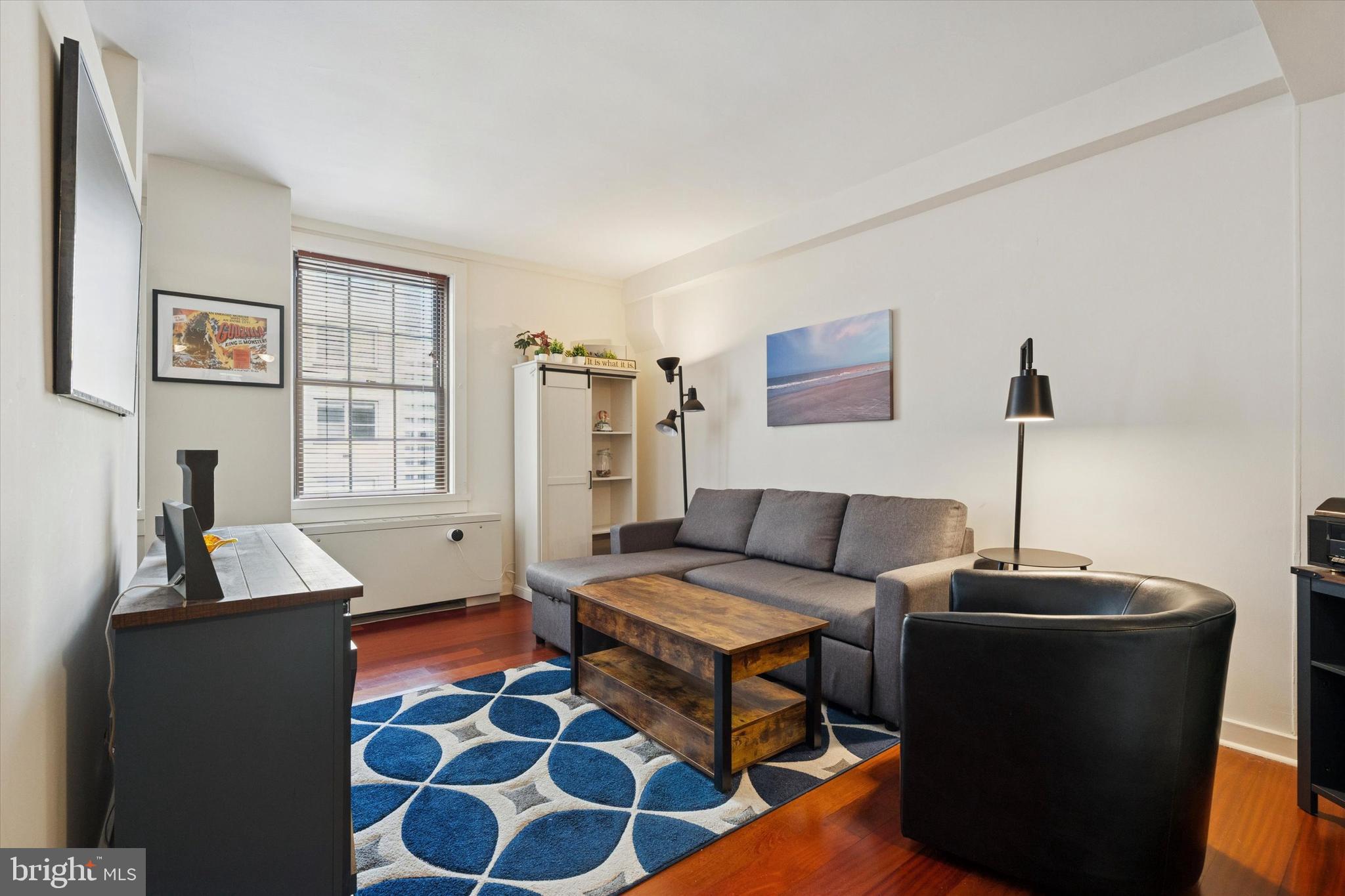 219 South 18th Street, Unit 902 Philadelphia, PA 19103 - Photo 3 of 14 a living room with furniture and a window