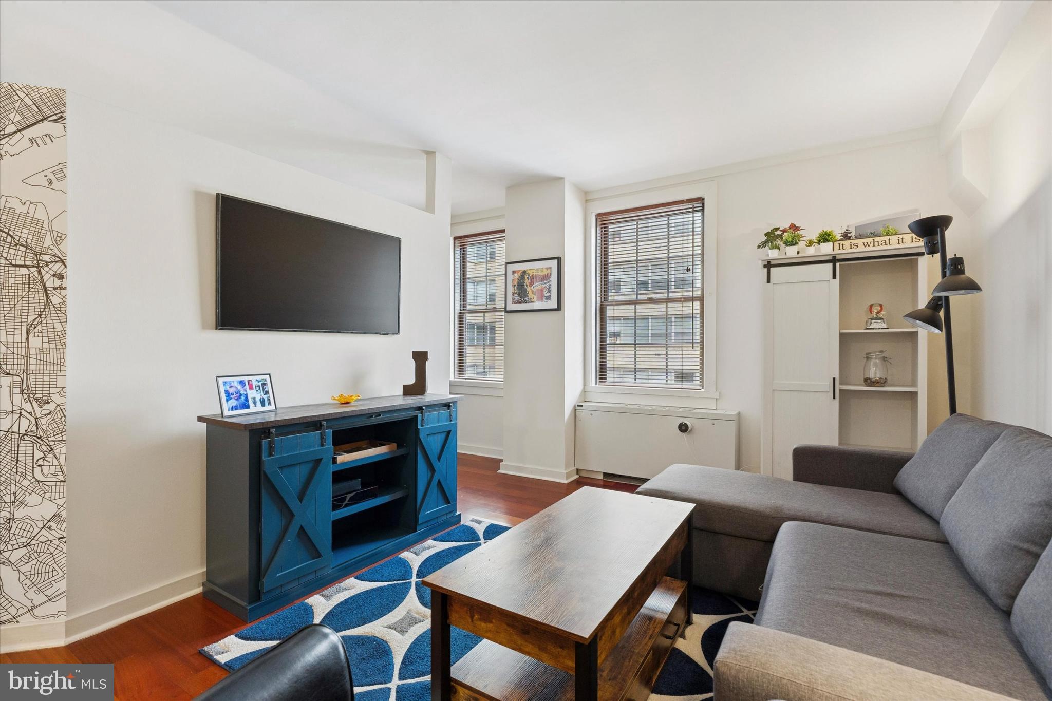 219 South 18th Street, Unit 902 Philadelphia, PA 19103 - Photo 4 of 14 a living room with furniture and a flat screen tv