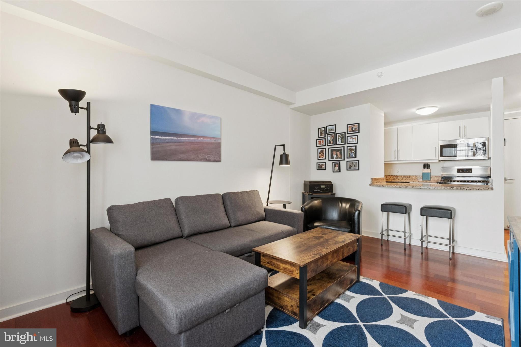 219 South 18th Street, Unit 902 Philadelphia, PA 19103 - Photo 5 of 14 a living room with furniture and wooden floor