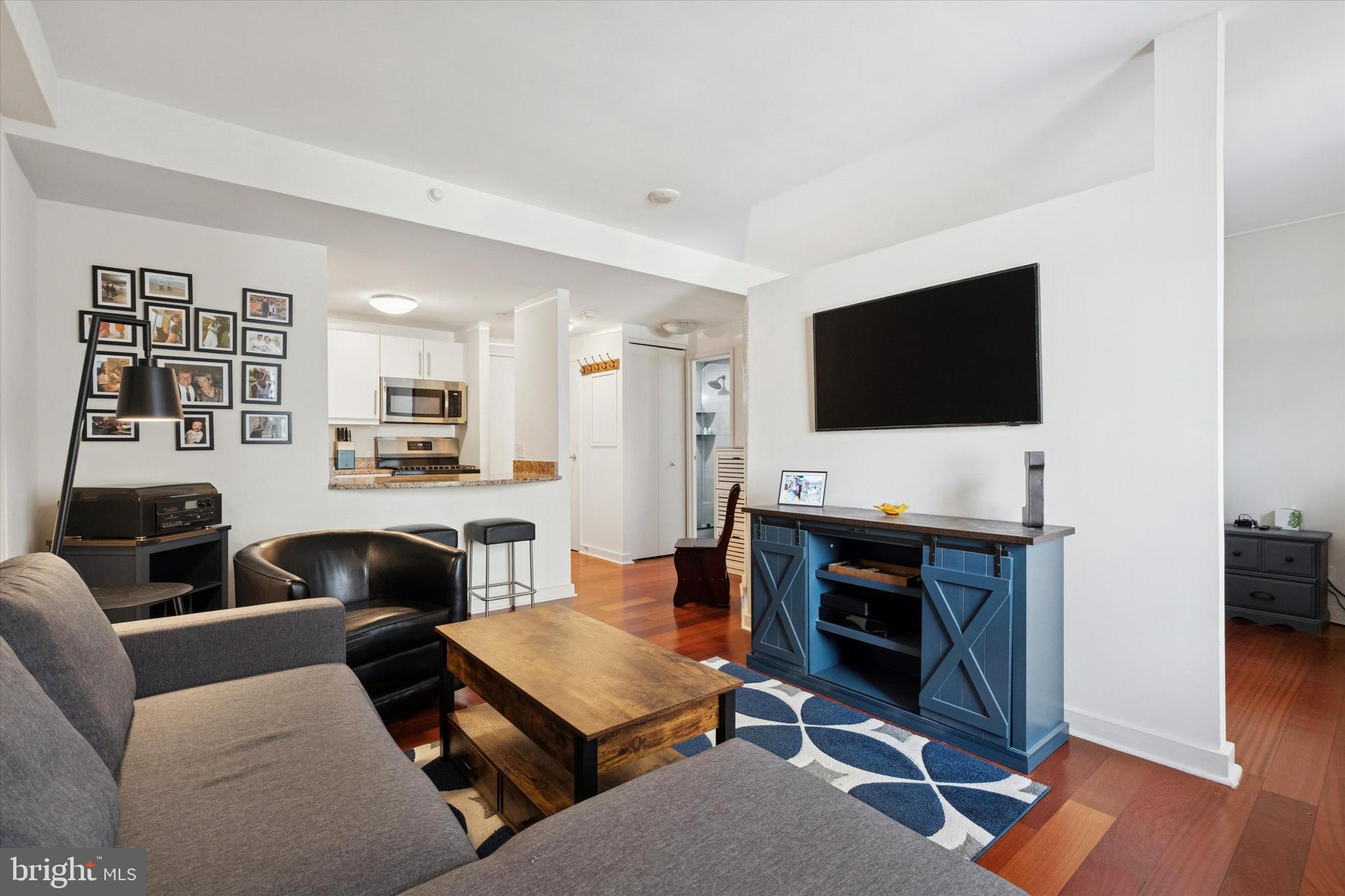 219 South 18th Street, Unit 902 Philadelphia, PA 19103 - Photo 6 of 14 a living room with furniture and a flat screen tv