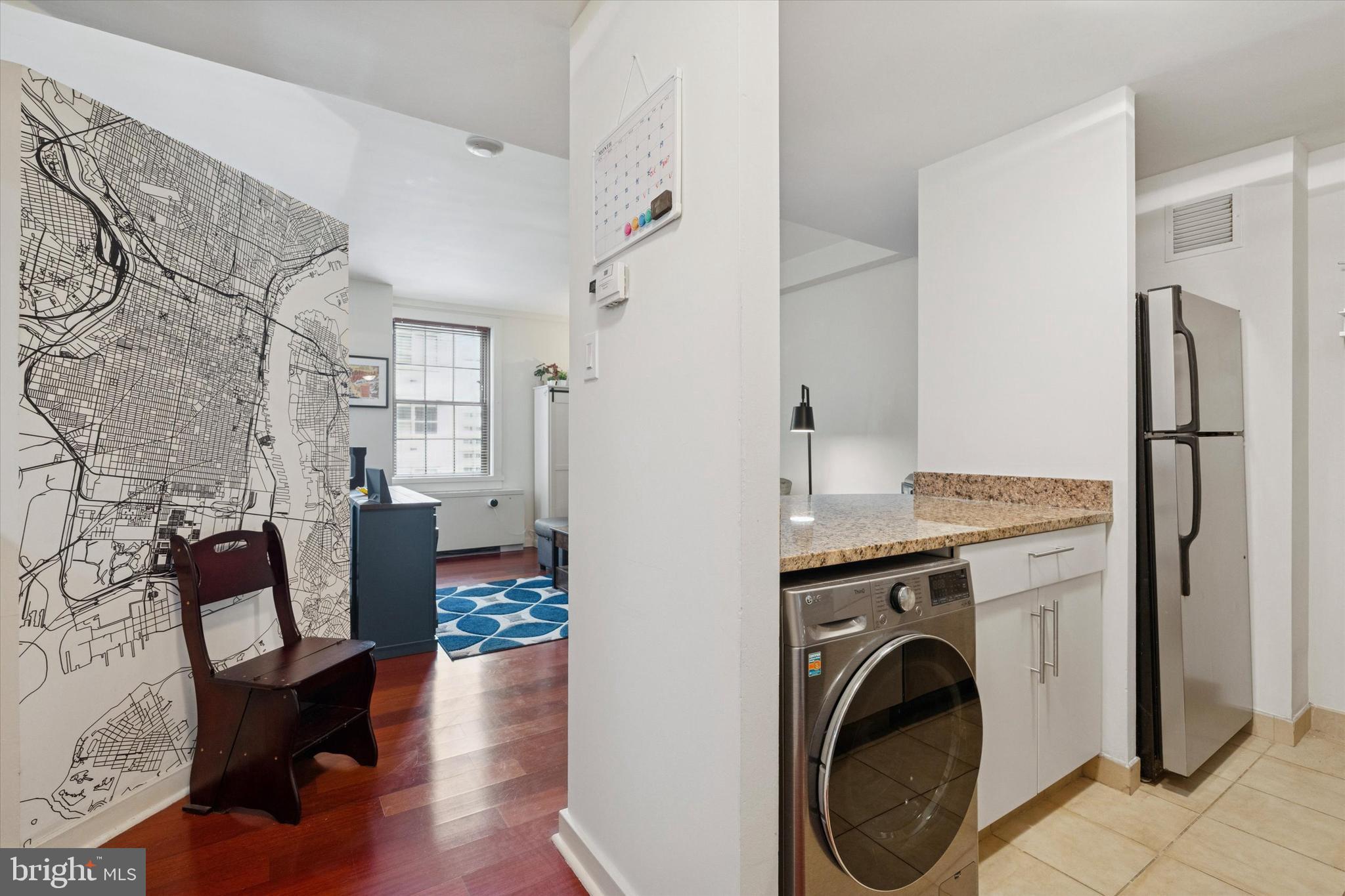 219 South 18th Street, Unit 902 Philadelphia, PA 19103 - Photo 7 of 14 a room with furniture a washer and dryer