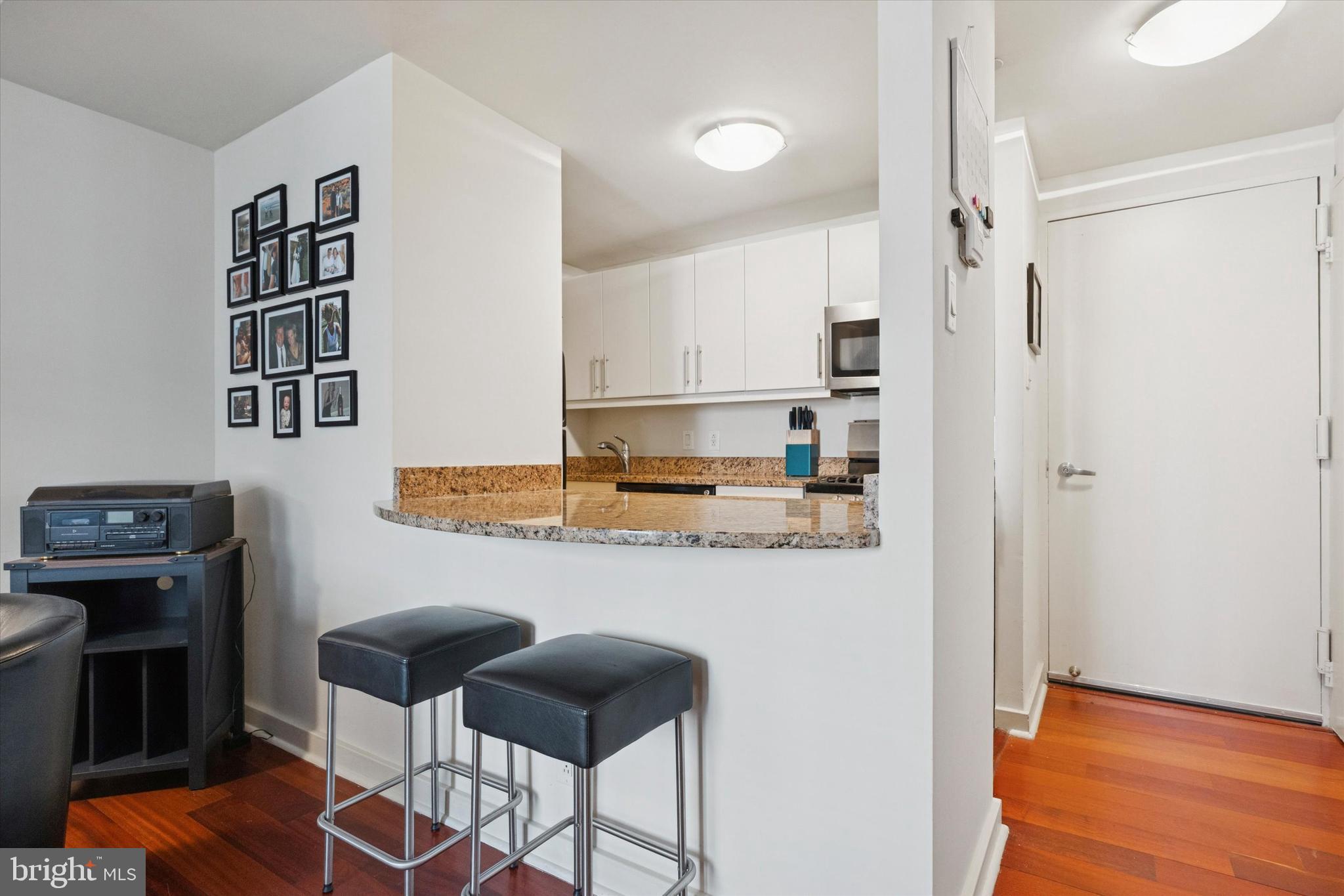 219 South 18th Street, Unit 902 Philadelphia, PA 19103 - Photo 10 of 14 a kitchen with stainless steel appliances granite countertop a refrigerator and a stove top oven