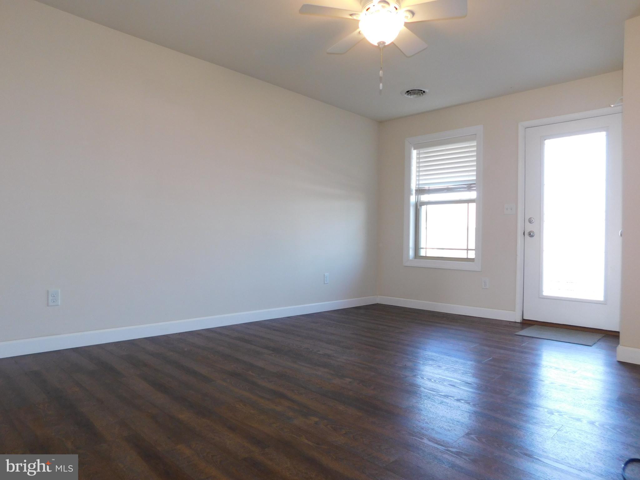 424 Eisenhower Drive Chambersburg, PA 17201 - Photo 13 of 30 an empty room with wooden floor and windows
