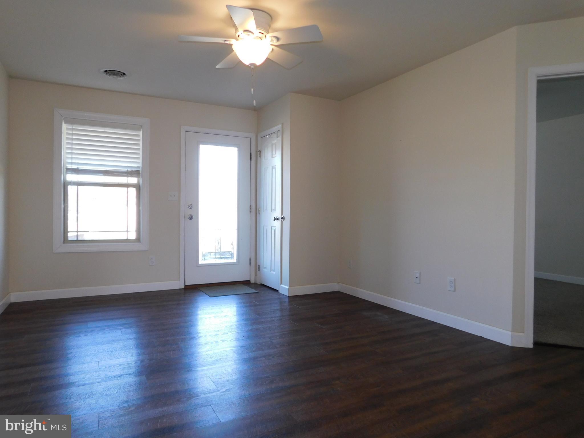 424 Eisenhower Drive Chambersburg, PA 17201 - Photo 14 of 30 a view of an empty room with wooden floor and a window