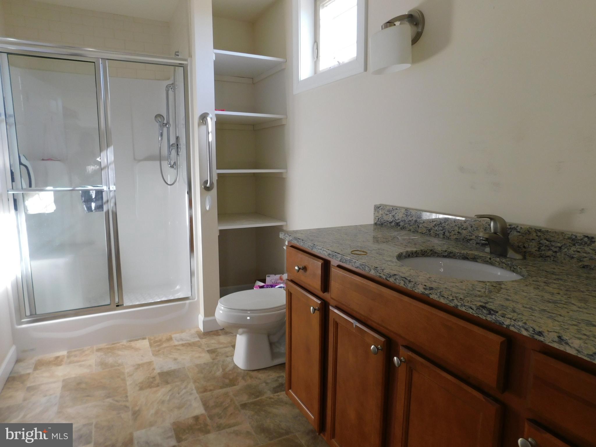 424 Eisenhower Drive Chambersburg, PA 17201 - Photo 24 of 30 a bathroom with a granite countertop sink toilet and shower
