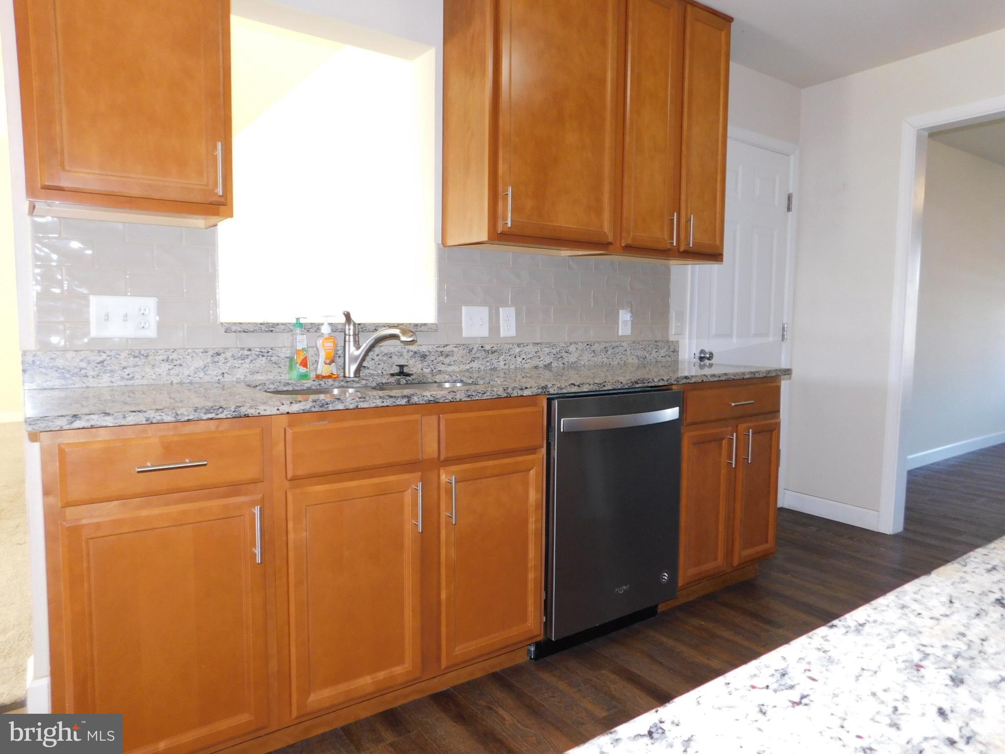 424 Eisenhower Drive Chambersburg, PA 17201 - Photo 5 of 30 a kitchen with granite countertop cabinets sink and wooden floor