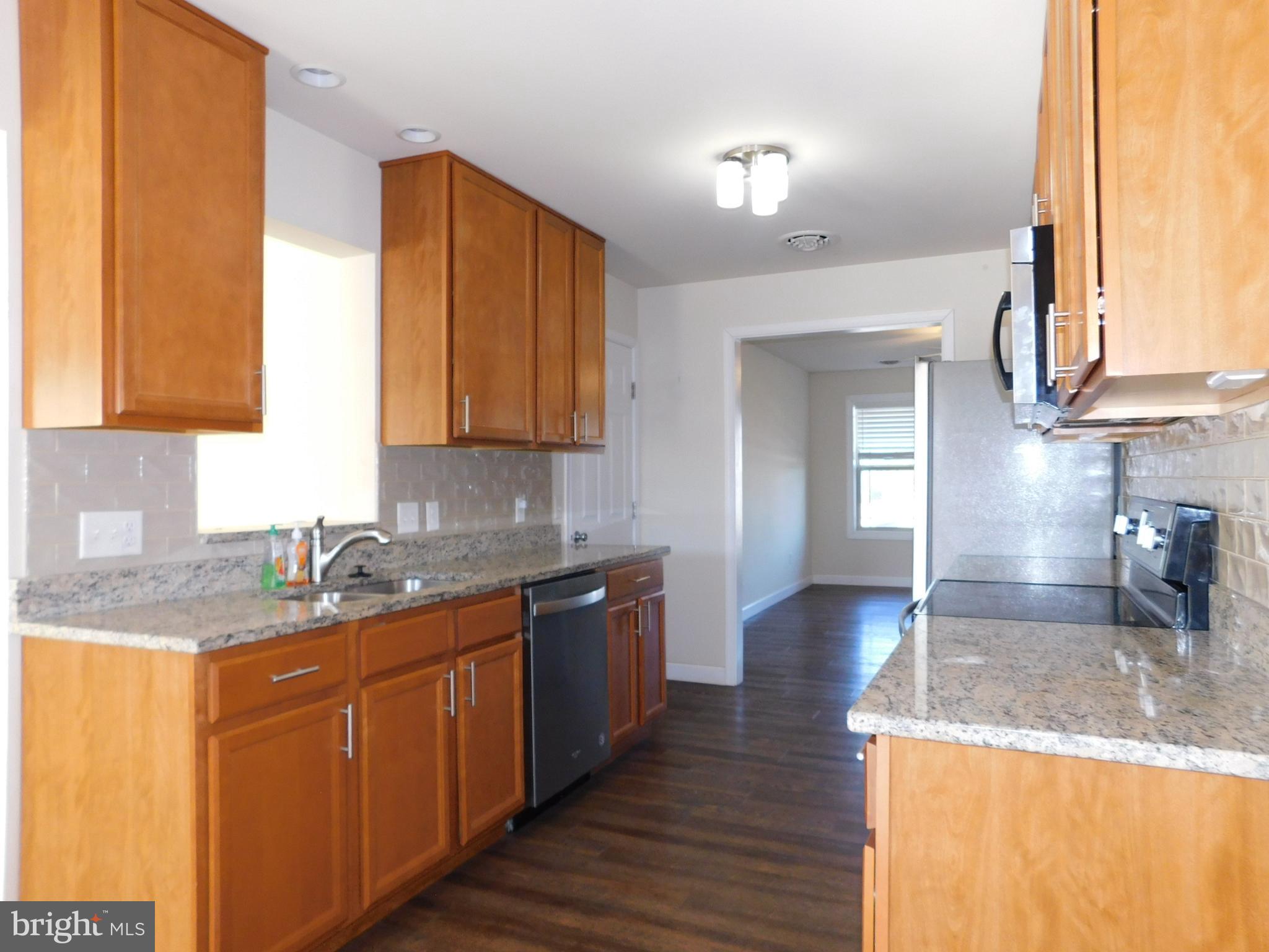 424 Eisenhower Drive Chambersburg, PA 17201 - Photo 6 of 30 a kitchen with stainless steel appliances granite countertop wooden cabinets a sink and dishwasher