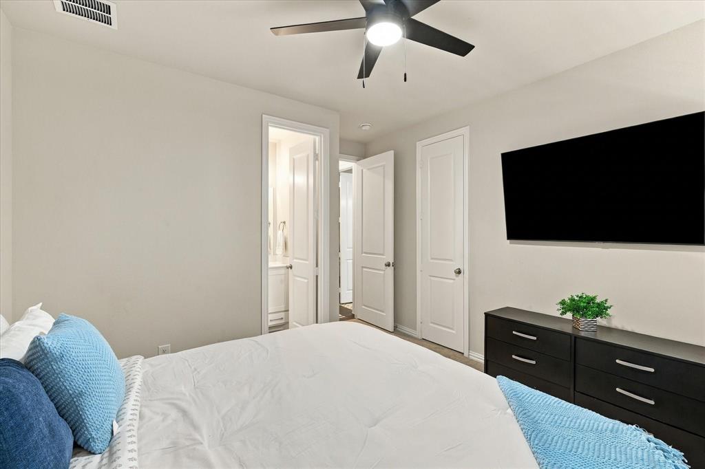 137 Chisos Court Rhome, TX 76078 - Photo 36 of 40 Neutral wall tones, ceiling fan with integrated lighting, and wood-finish flooring