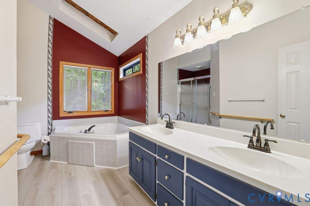 1061 Turkey Ridge Drive Moseley, VA 23120 - Photo 20 of 51 a bathroom with a double vanity sink a mirror and a bathtub