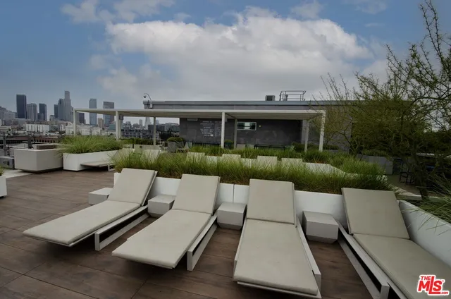 an outdoor sitting area with furniture and city view
