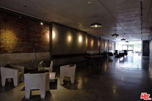 a view of a room with lots of furniture and wooden floor