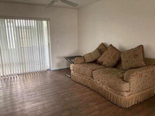 2894 East Crosley Drive, Unit J West Palm Beach, FL 33415 - Photo 2 of 11 a living room with furniture and a large window