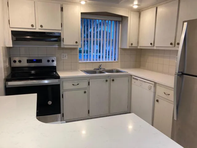 a kitchen with a sink and a stove