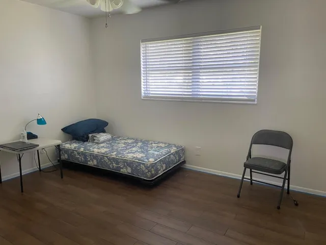 a bedroom with a bed and a chair