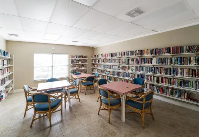 a view of a dining room with furniture and a bookshelf
