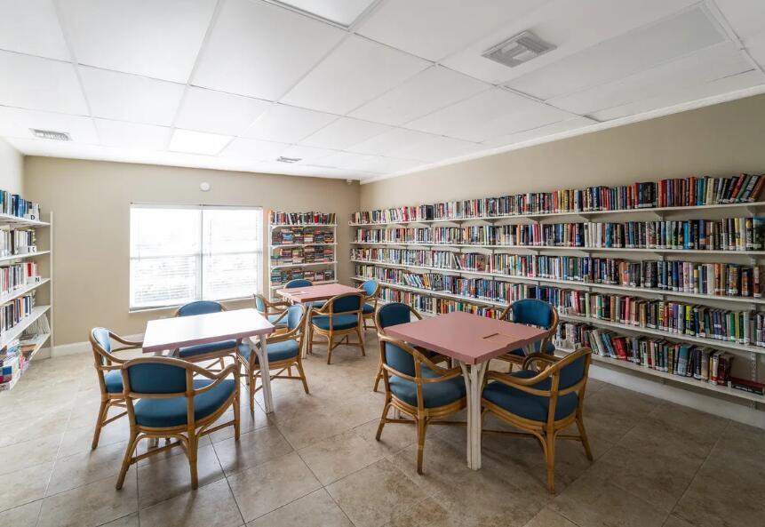 2894 East Crosley Drive, Unit J West Palm Beach, FL 33415 - Photo 9 of 11 a view of a dining room with furniture and a bookshelf