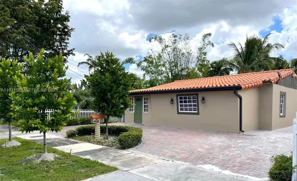 a house with trees in the background