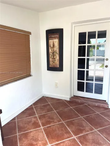 a view of a room with wooden floor and window