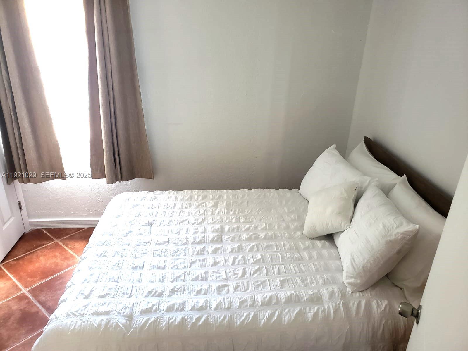 635 Southwest 64th Court Miami, FL 33144 - Photo 26 of 33 a bedroom with a bed and a window