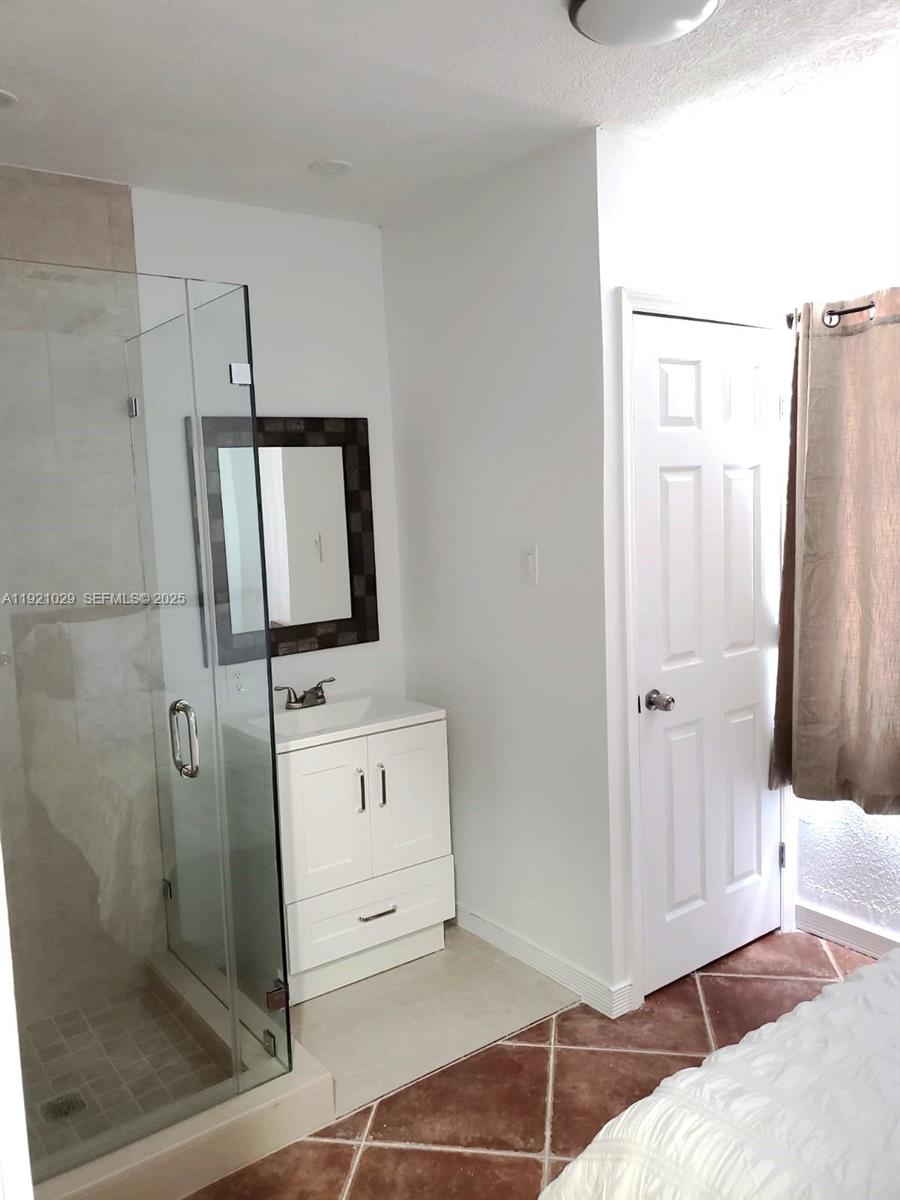 635 Southwest 64th Court Miami, FL 33144 - Photo 27 of 33 a bathroom with a sink a toilet and mirror