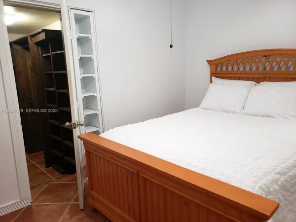 a bedroom with a bed and cabinets