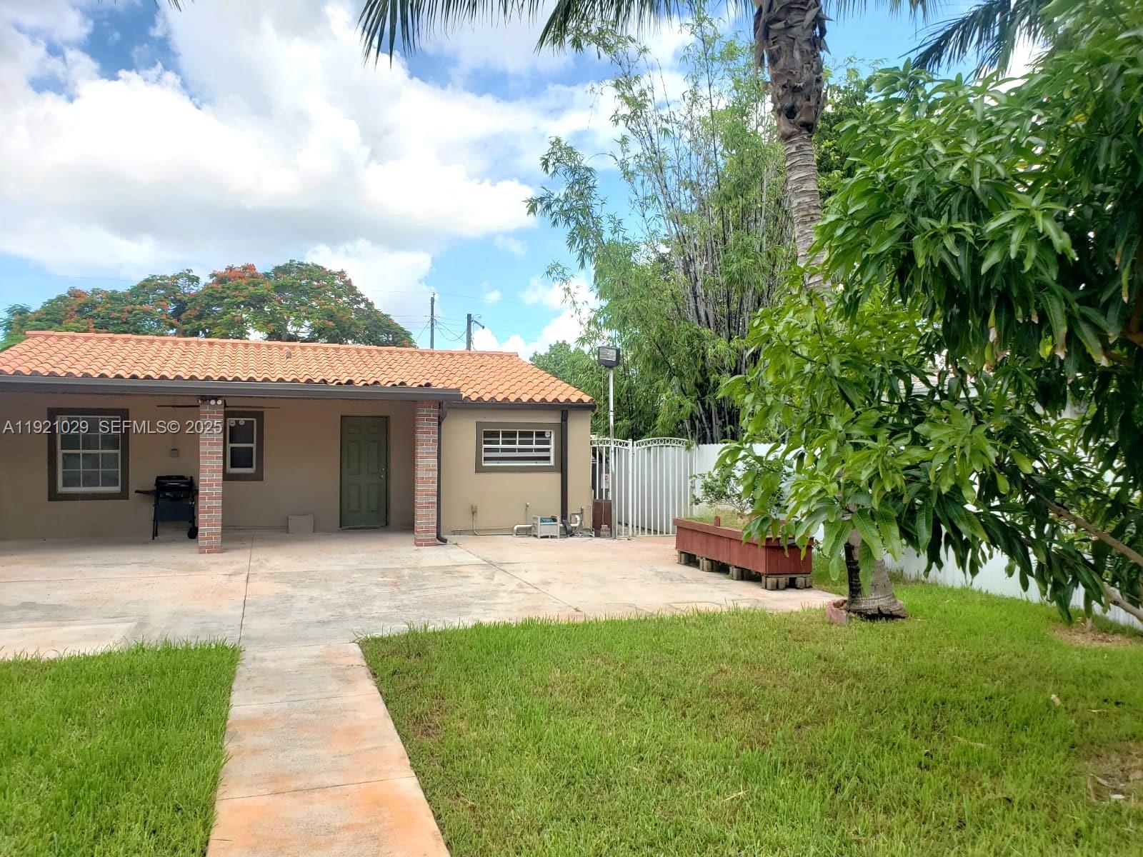 635 Southwest 64th Court Miami, FL 33144 - Photo 32 of 33 a front view of a house with a garden and trees