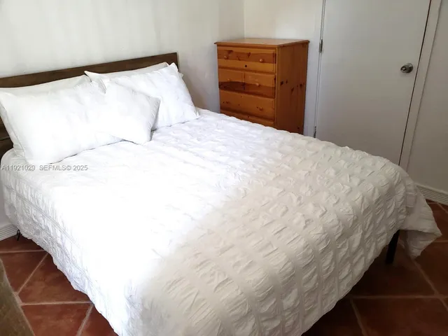 a bedroom with a bed and dresser