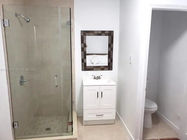 a bathroom with a toilet a sink and shower