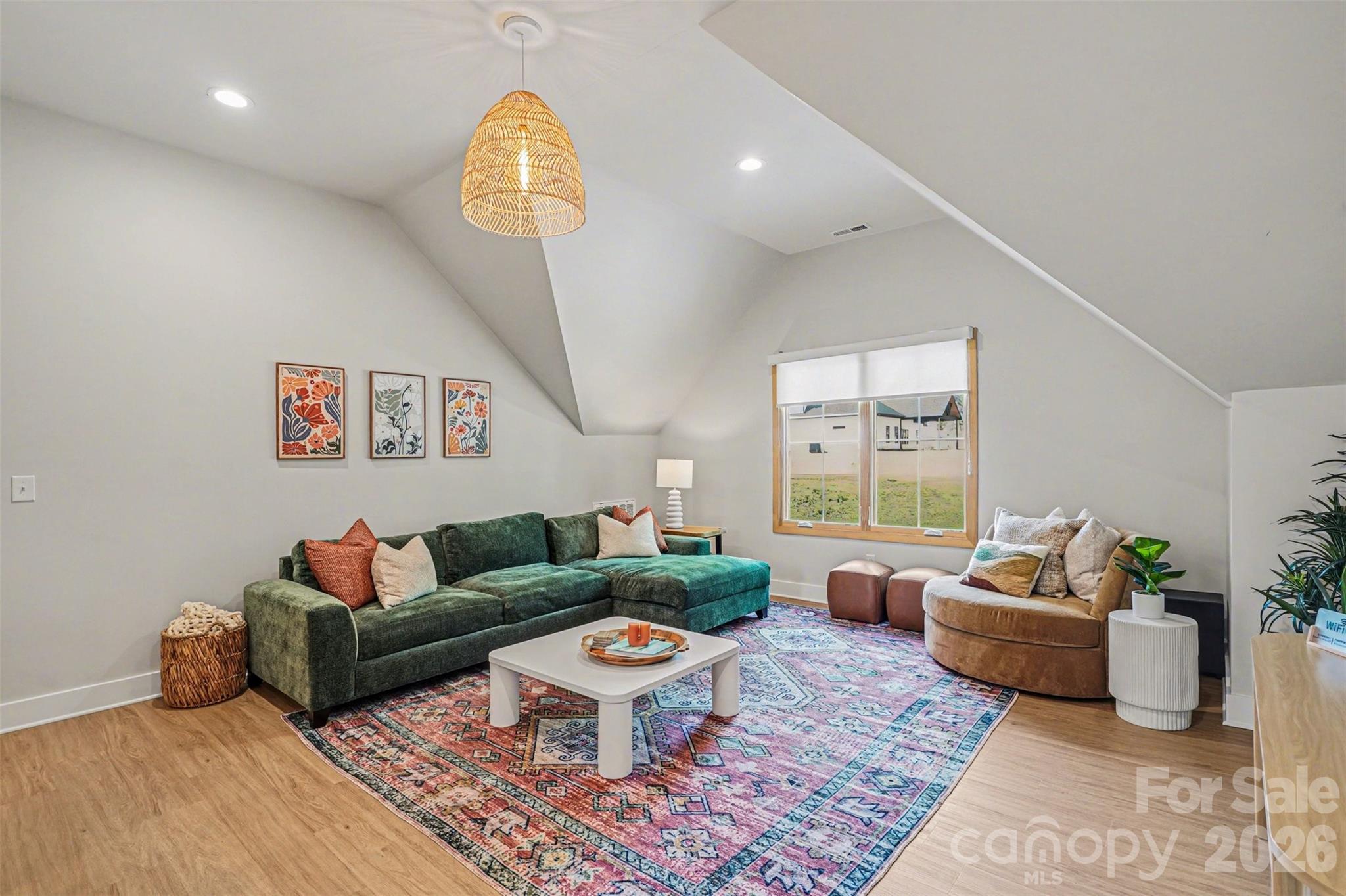 12141 Coyle Road, Unit 12 Stanfield, NC 28163 - Photo 18 of 28 a living room with furniture a rug and a chandelier