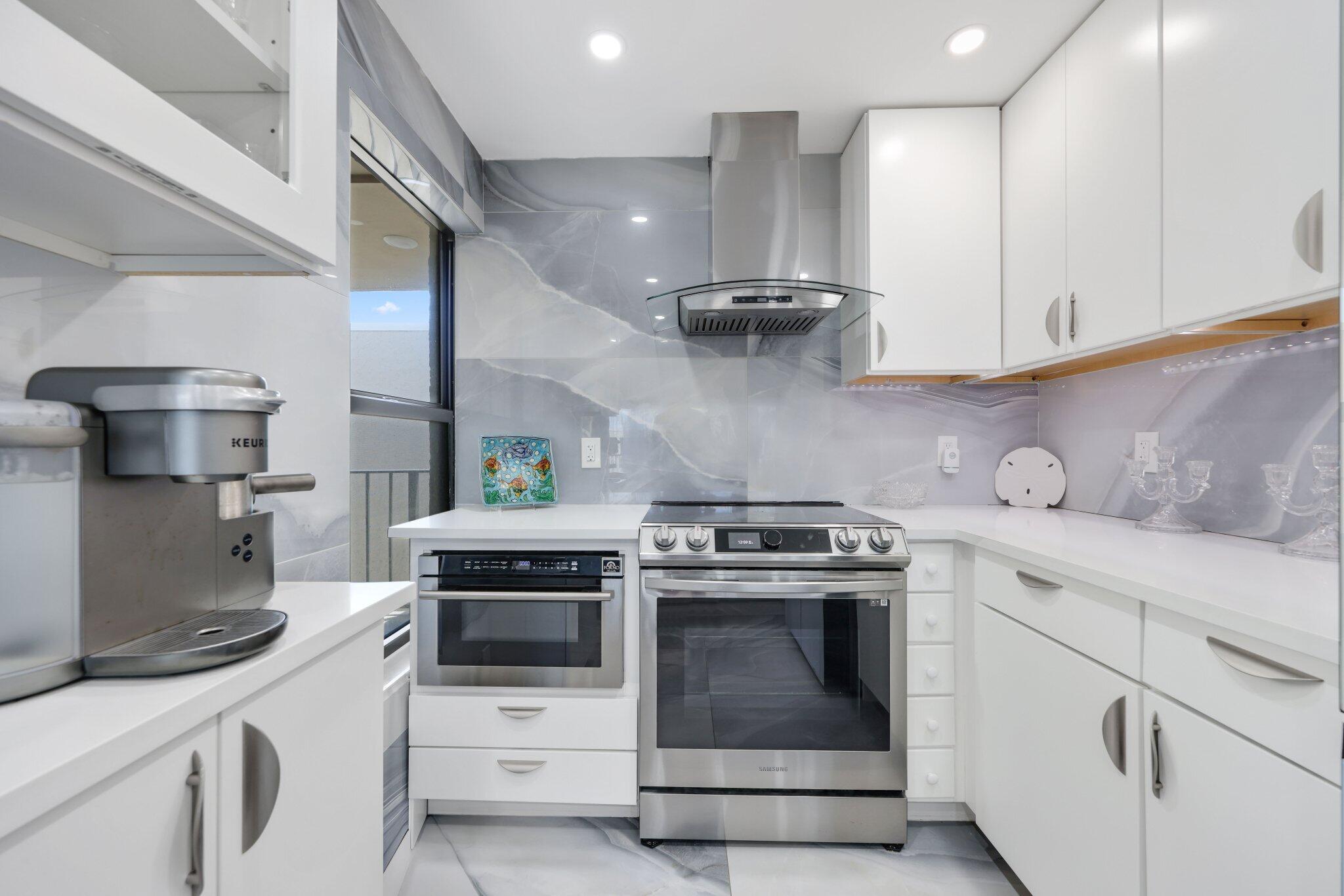 12 Royal Palm Way, Unit 605 Boca Raton, FL 33432 - Photo 12 of 47 a kitchen with a stove and a sink