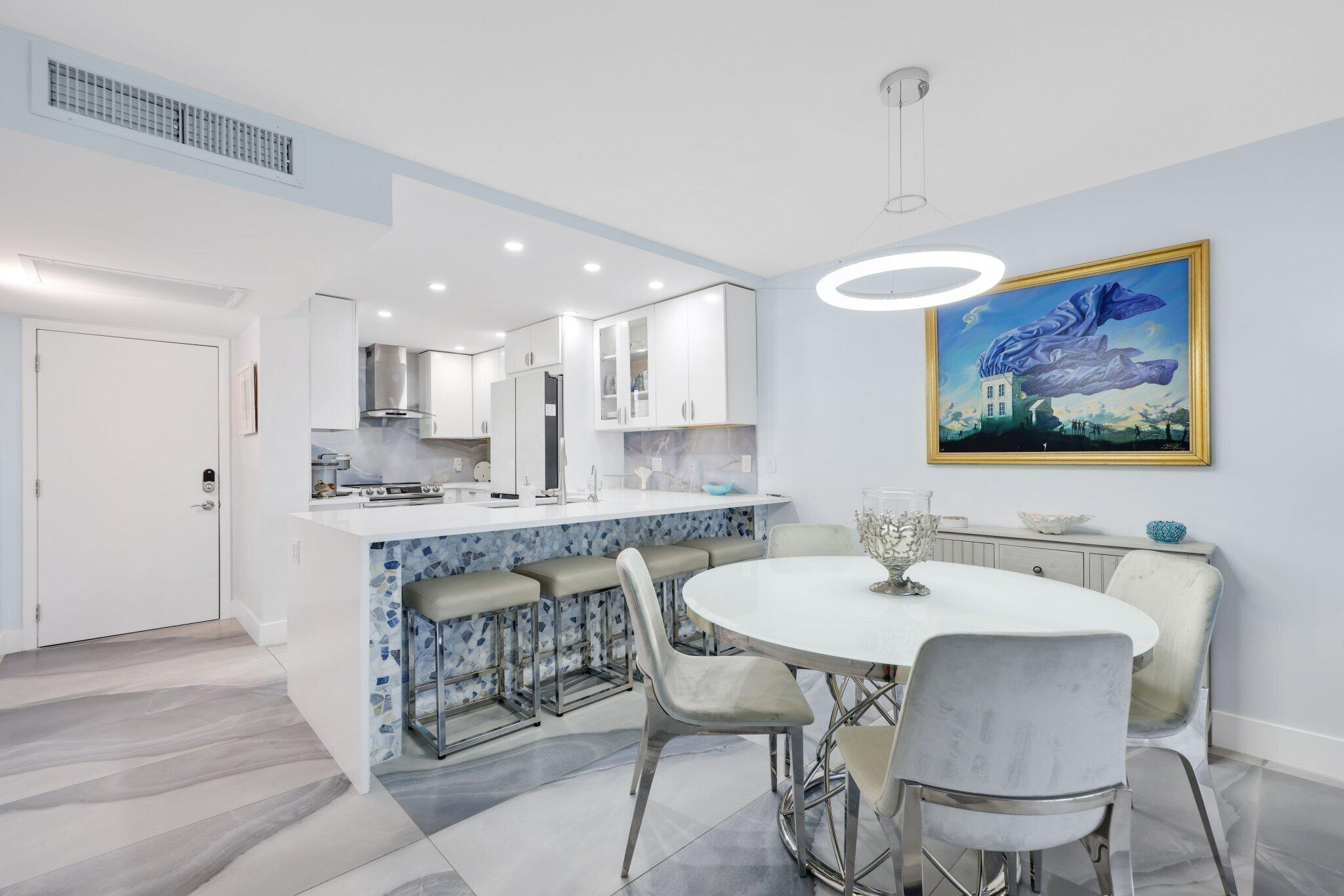 12 Royal Palm Way, Unit 605 Boca Raton, FL 33432 - Photo 13 of 47 a view of a dining room with furniture and wooden floor