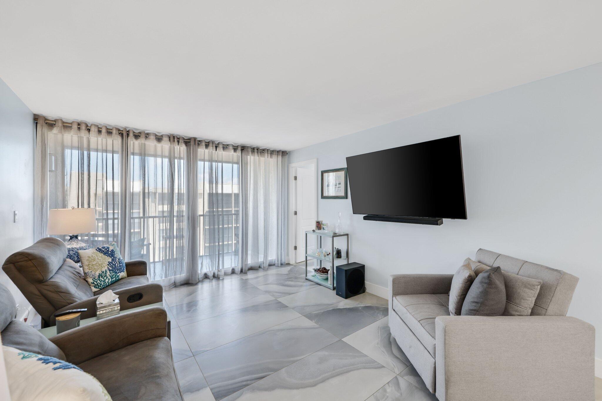 12 Royal Palm Way, Unit 605 Boca Raton, FL 33432 - Photo 16 of 47 a living room with furniture and a flat screen tv