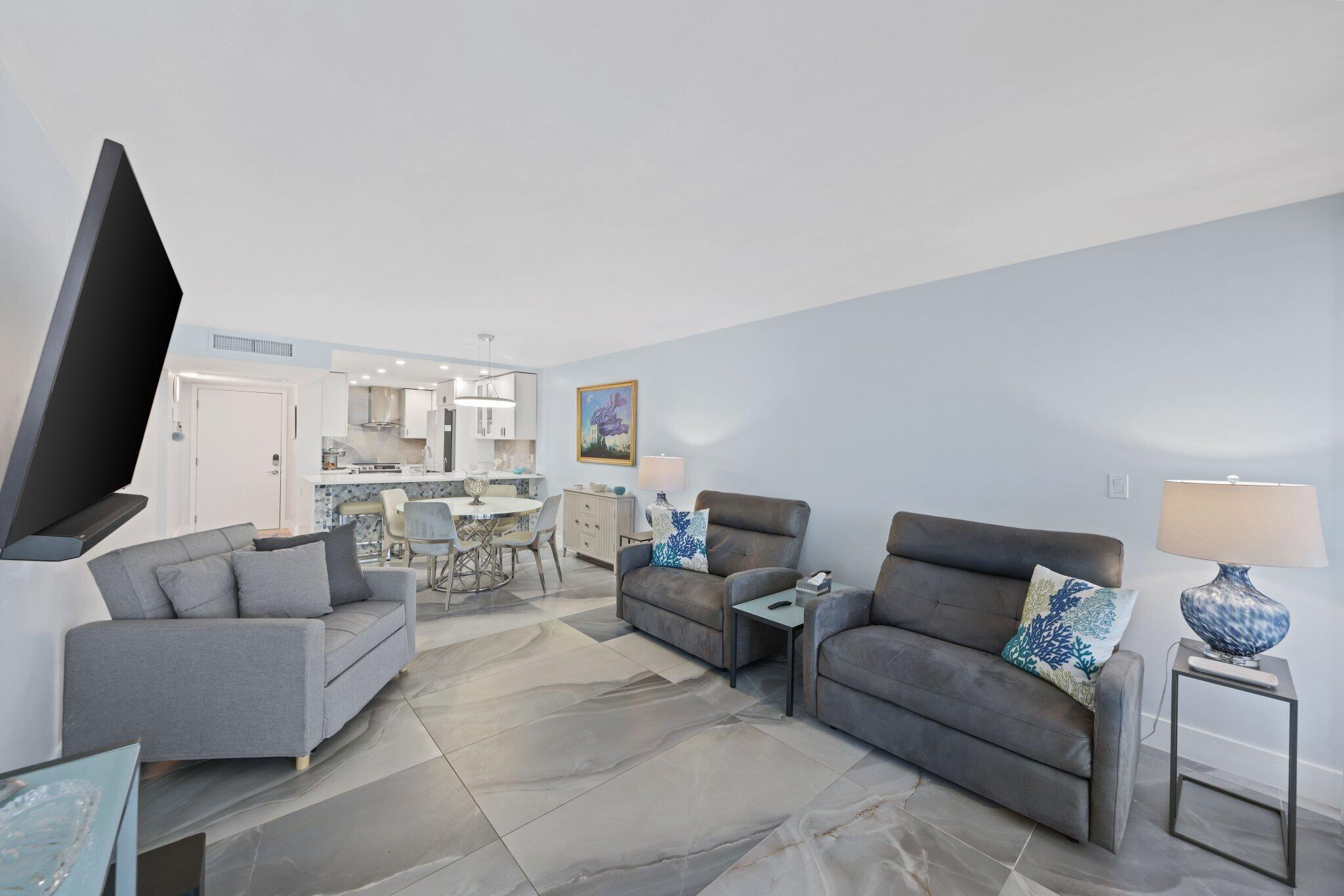 12 Royal Palm Way, Unit 605 Boca Raton, FL 33432 - Photo 17 of 47 a living room with furniture and a flat screen tv