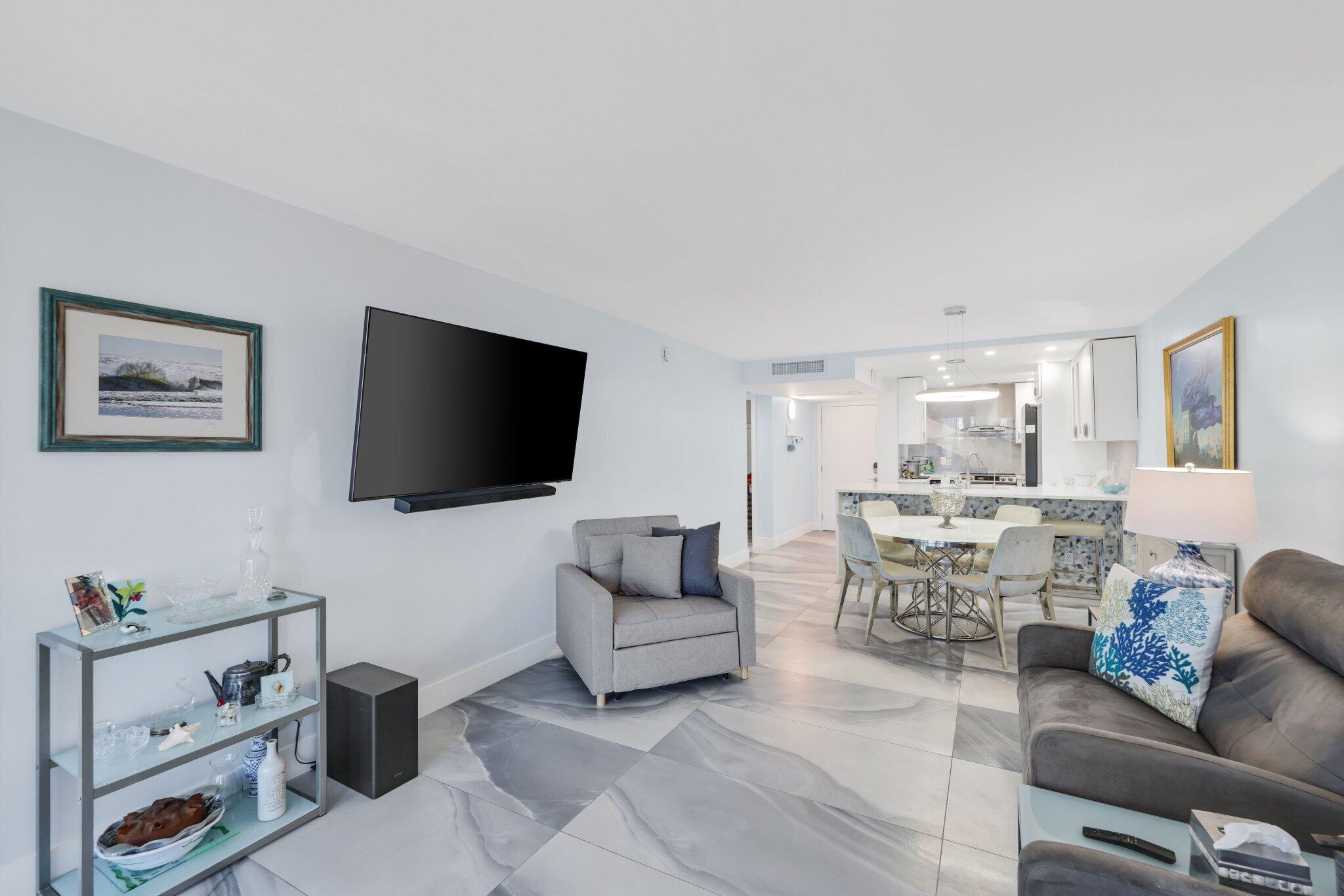 12 Royal Palm Way, Unit 605 Boca Raton, FL 33432 - Photo 18 of 47 a living room with furniture and a flat screen tv